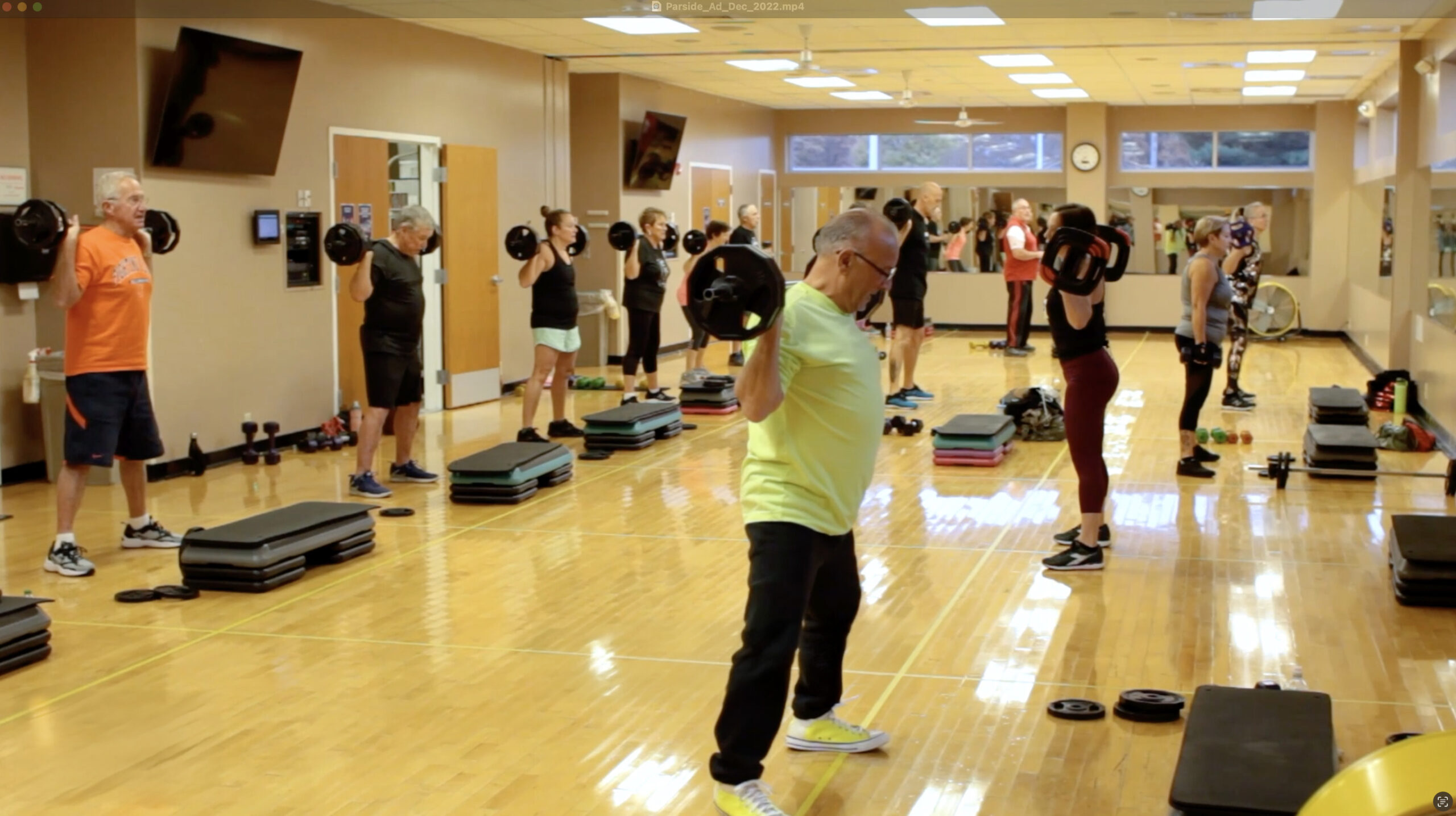 Instructor leading fitness group x fitness class.